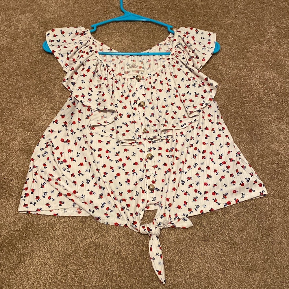 White blouse ruffle top tie at bottom with red and white roses